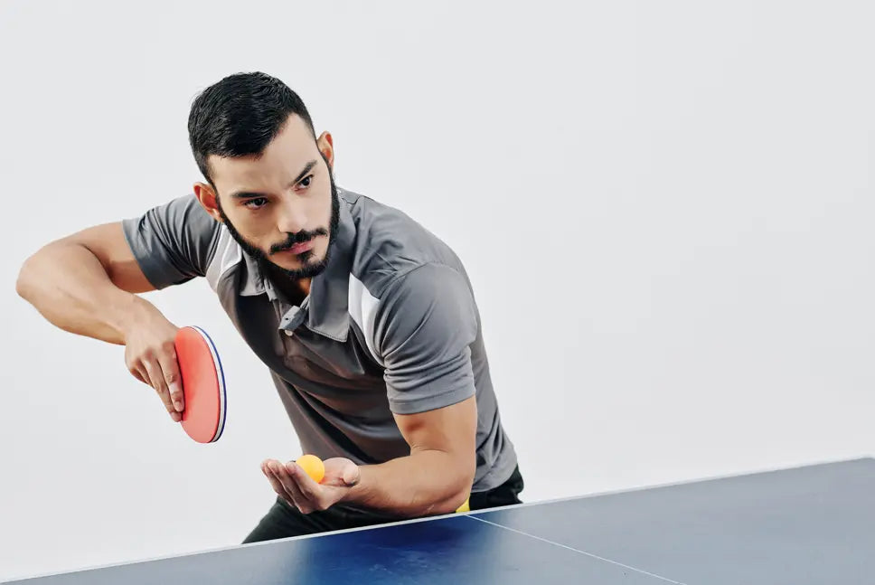 man playing Table tennis intensively 